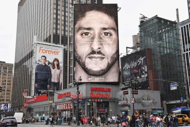 A Nike Ad featuring American football quarterback Colin Kaepernick is on diplay September 8, 2018 in New York City. - Nike's new ad campaign featuring Kaepernick, the American football player turned activist against police violence, takes a strong stance on a divisive issue which could score points with millennials but risks alienating conservative customers. The ads prompted immediate calls for Nike boycotts over Kaepernick, who has been castigated by US President Donald Trump and other conservatives over his kneeling protests during the playing of the US national anthem. (Photo by Angela Weiss / AFP) (Photo credit should read ANGELA WEISS/AFP/Getty Images)